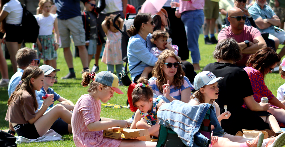 Families eating picnic on the grass at Royal William Yard